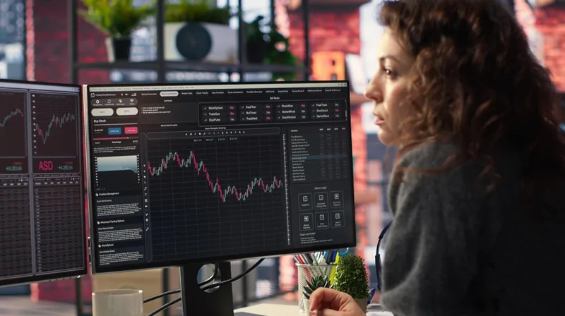 A day trader watching an intraday chart on a desktop monitor