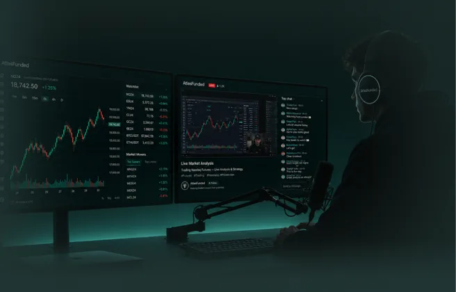 A trader at a desk with two screens of Atlas charts